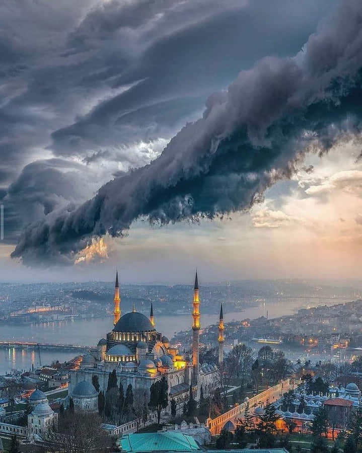 Captivating Aerial View Of The Blue Mosque Under Stormy Clouds Wallpaper