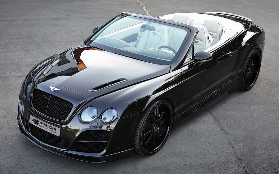 Captivating Convertible On A Scenic Mountain Road Wallpaper