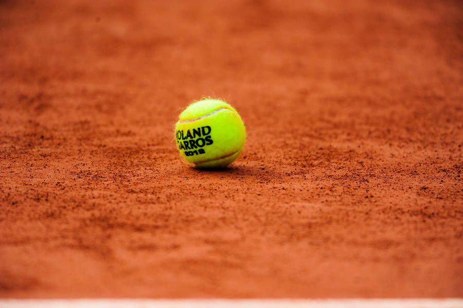 Captivating Focus On Tennis Ball At French Open Wallpaper