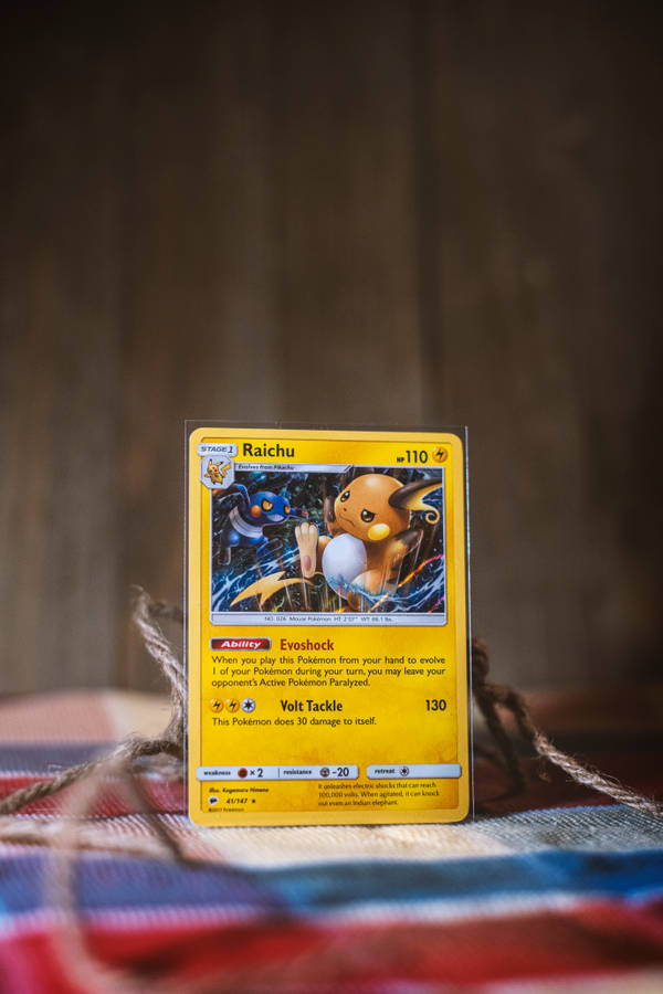 Captivating Illustration Of Raichu In A Vibrant Landscape Wallpaper