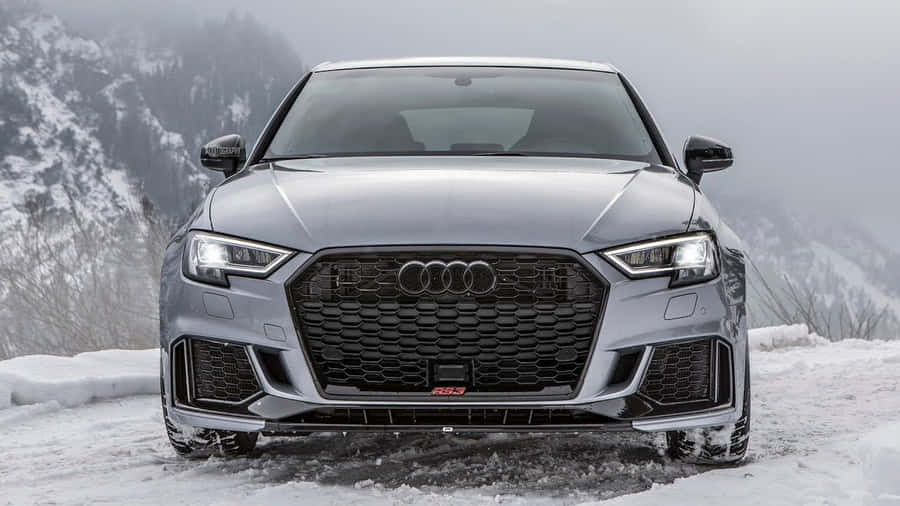 Captivating Silver Sedan On A Scenic Road Wallpaper