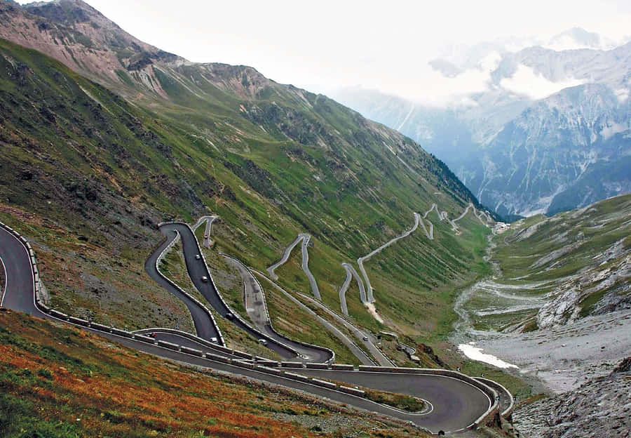 Cars Passing On The Mountain Road Wallpaper