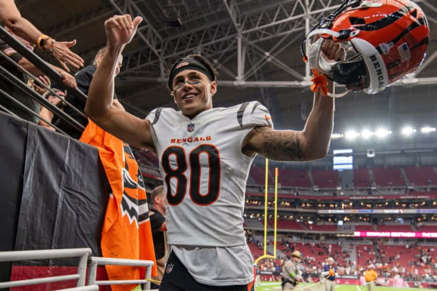 Celebratory Football Player High Fiving Fans Wallpaper