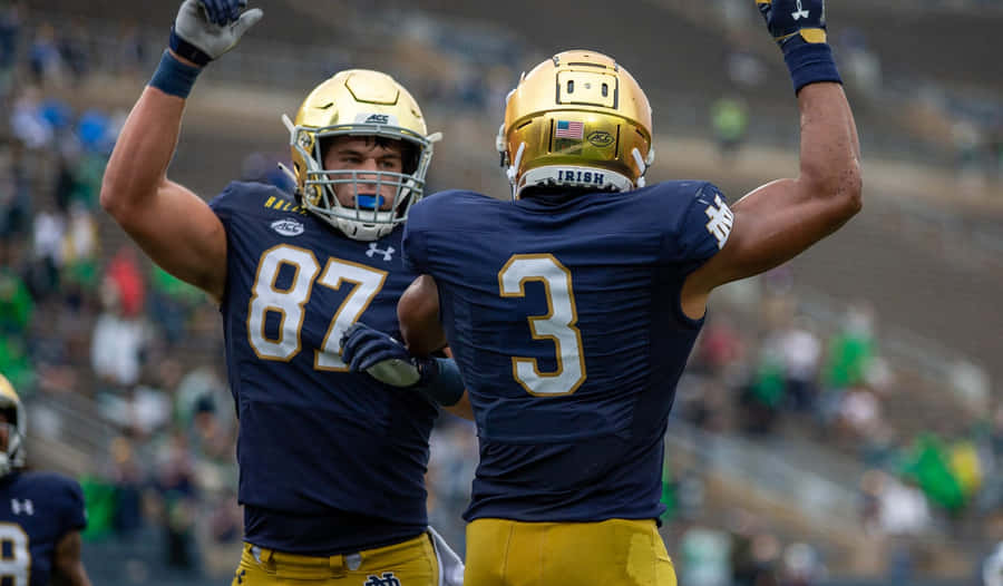 Celebratory Football Players High Five Wallpaper