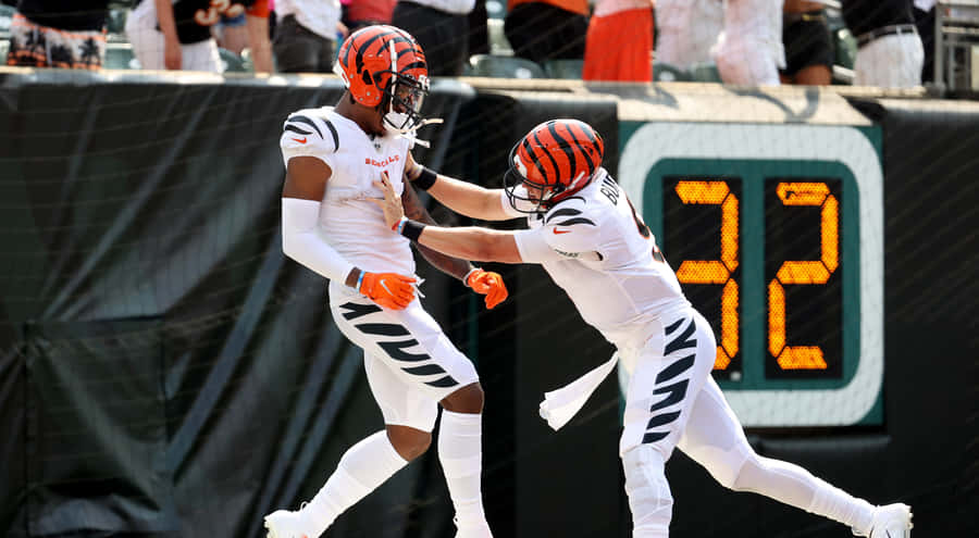 Celebratory Football Players High Five Wallpaper