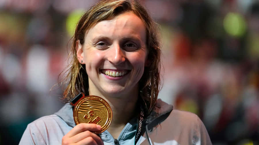 Champion Swimmerwith Gold Medal Wallpaper