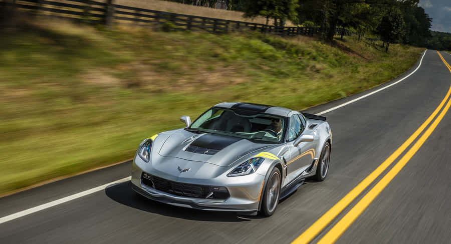 Chevrolet Corvette Grand Sport Cruising On An Open Road Wallpaper