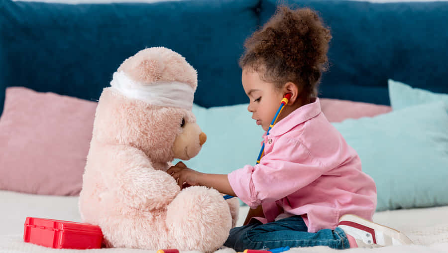 Child Doctor Playingwith Teddy Bear Wallpaper