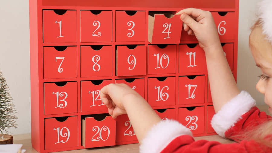 Child Opening Christmas Advent Calendar Wallpaper