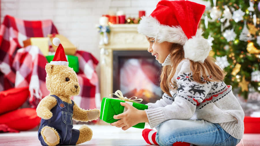 Child Wearing Christmas Hat Wallpaper