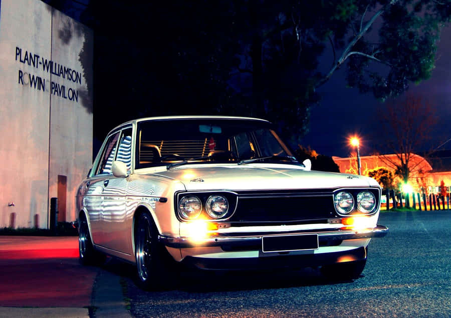Classic Datsun 1600 Cruising On The Open Road Wallpaper