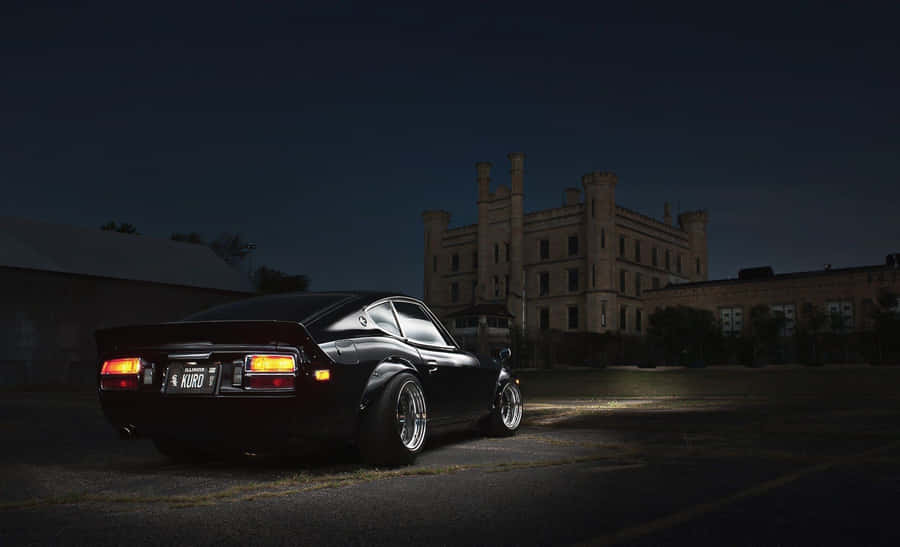 Classic Datsun Car In Vibrant Blue Wallpaper