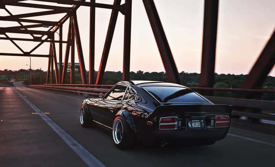 Classic Datsun On Display In A Beautiful Sunset Wallpaper