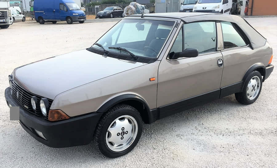 Classic Fiat Ritmo On Scenic Road Wallpaper