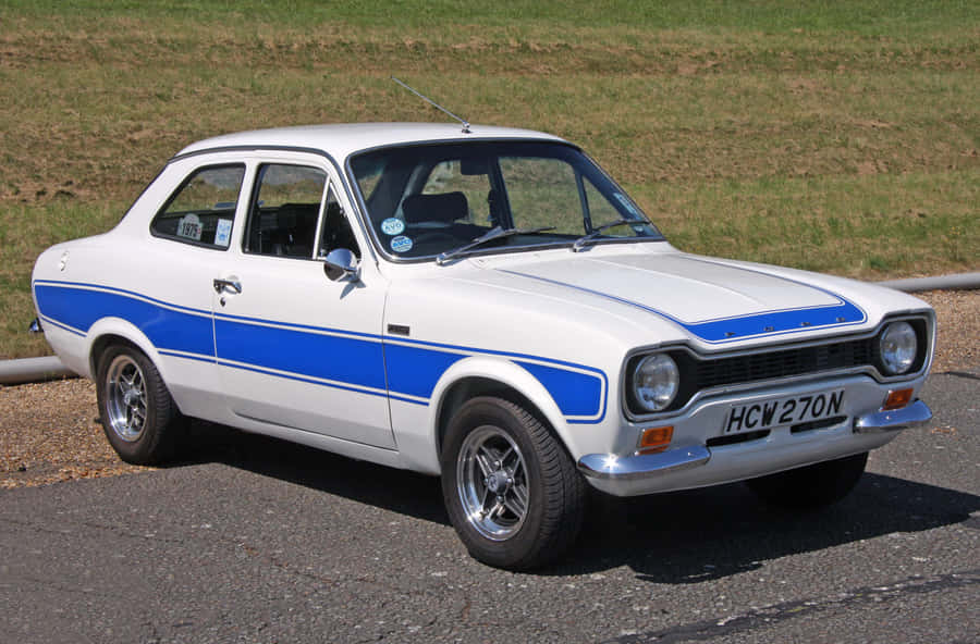 Classic Ford Escort On A Scenic Road Wallpaper