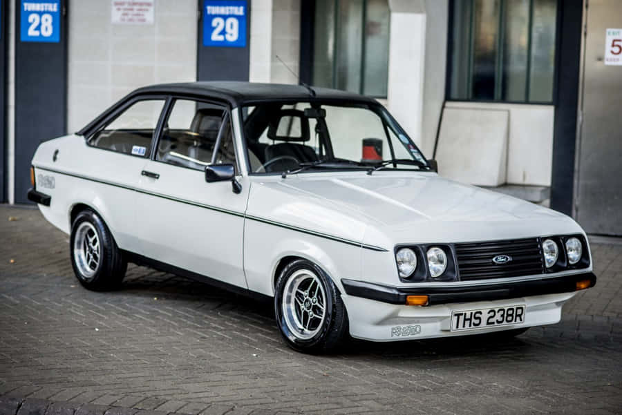 Classic Ford Escort Showcased At An Automobile Event Wallpaper