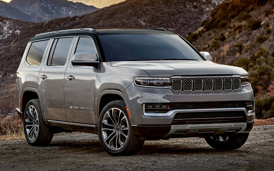 Classic Jeep Wagoneer In A Serene Forest Setting Wallpaper
