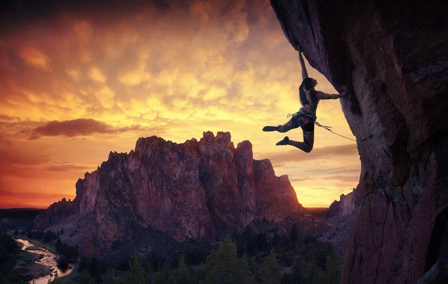 Climbing Female With Setting Sun Wallpaper