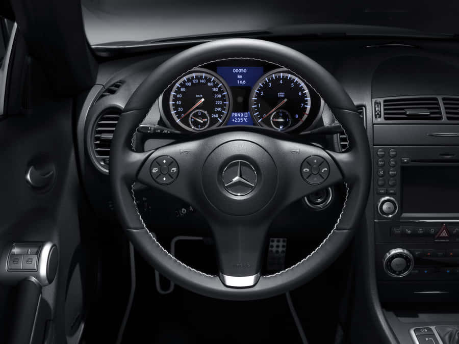 Close-up View Of A Modern Car's Steering Wheel Wallpaper