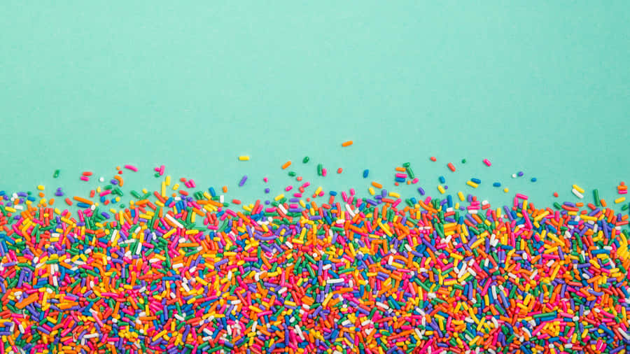 Colorful Sprinkleson Teal Background.jpg Wallpaper