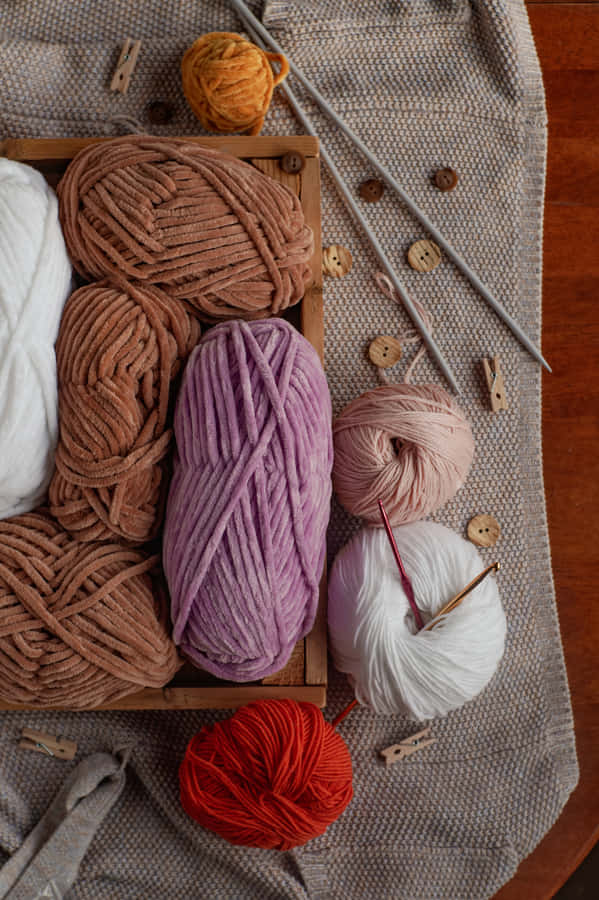 Colorful Yarnand Knitting Needles Wallpaper