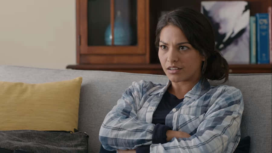 Concerned Woman On Couch.jpg Wallpaper