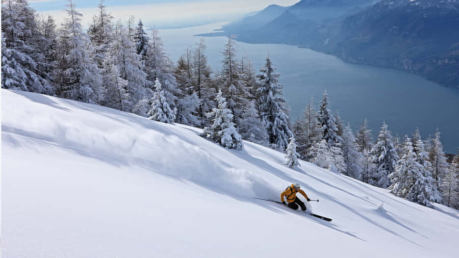 Conquer The Winter With Snow-capped Mountains And Ski Trails. Wallpaper