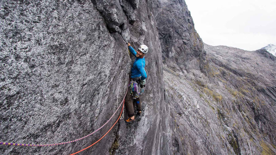 Conquering Peaks In Blue Wallpaper