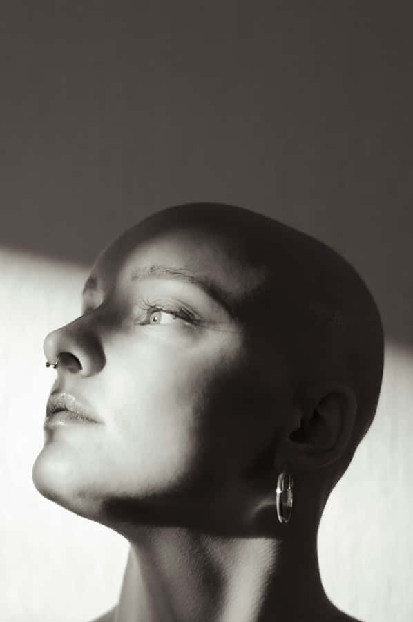 Contemplative Bald Woman Portrait Wallpaper