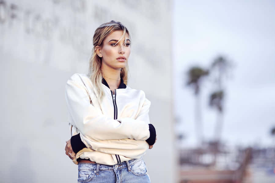 Contemplative Blonde Woman Outdoors Wallpaper