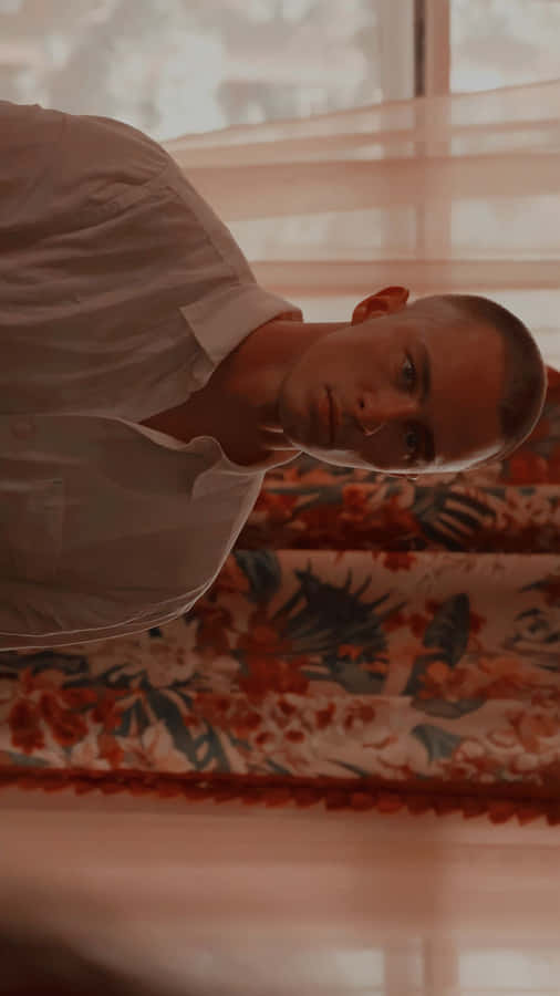 Contemplative Man Leaning Indoors Wallpaper