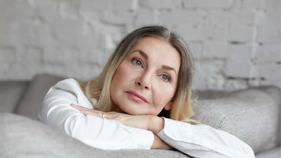 Contemplative Middle Aged Woman Resting Wallpaper