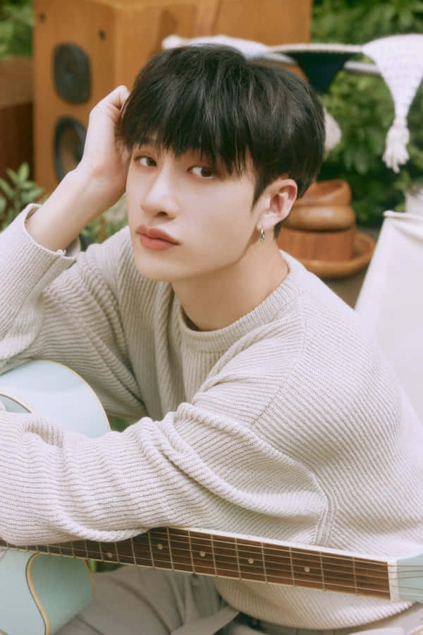 Contemplative Musician Garden Setting Wallpaper