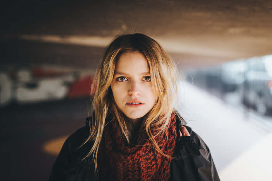 Contemplative Young Womanat Train Station Wallpaper