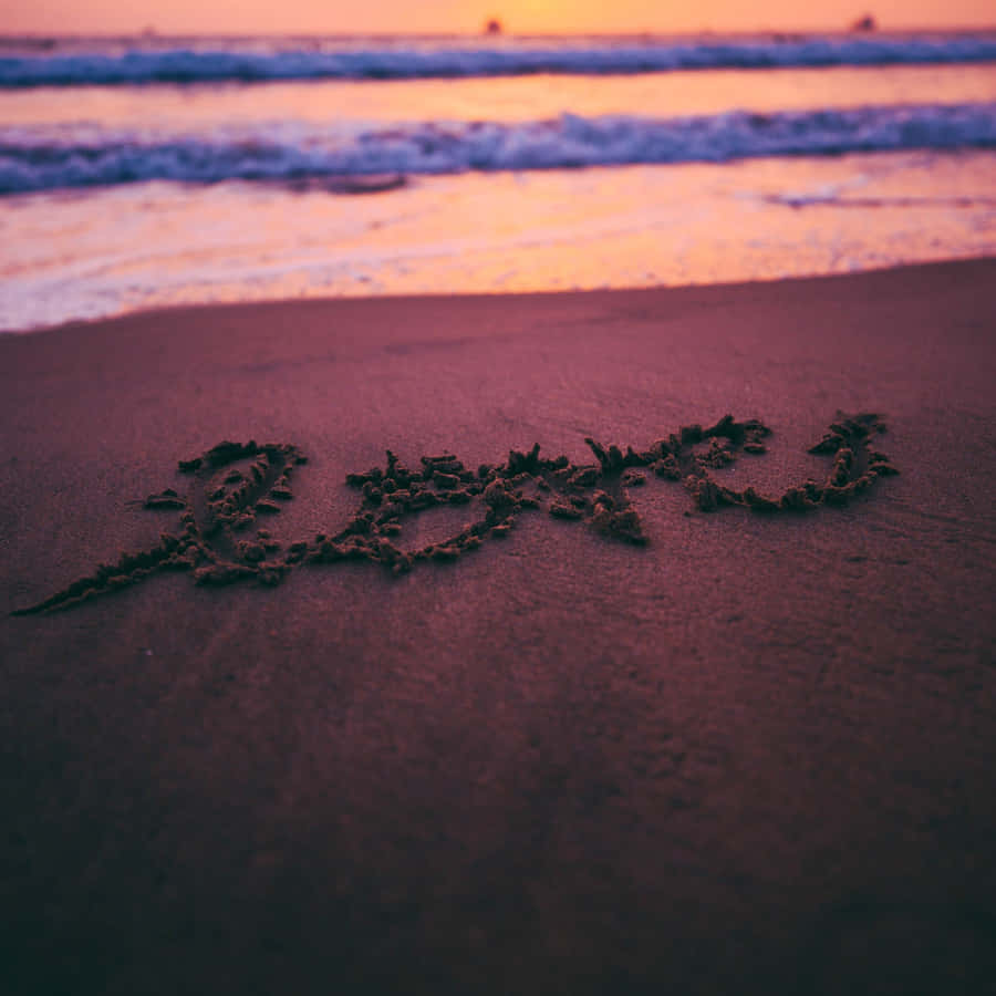 Couple Enjoying A Romantic Sunset At The Beach Wallpaper