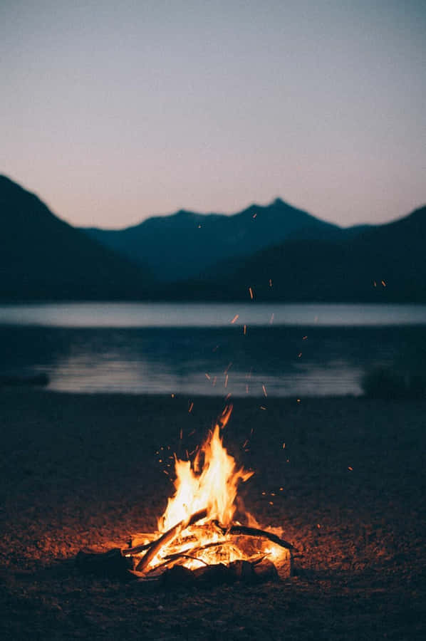 Cozy Fall Bonfire And Friends Gathering Wallpaper