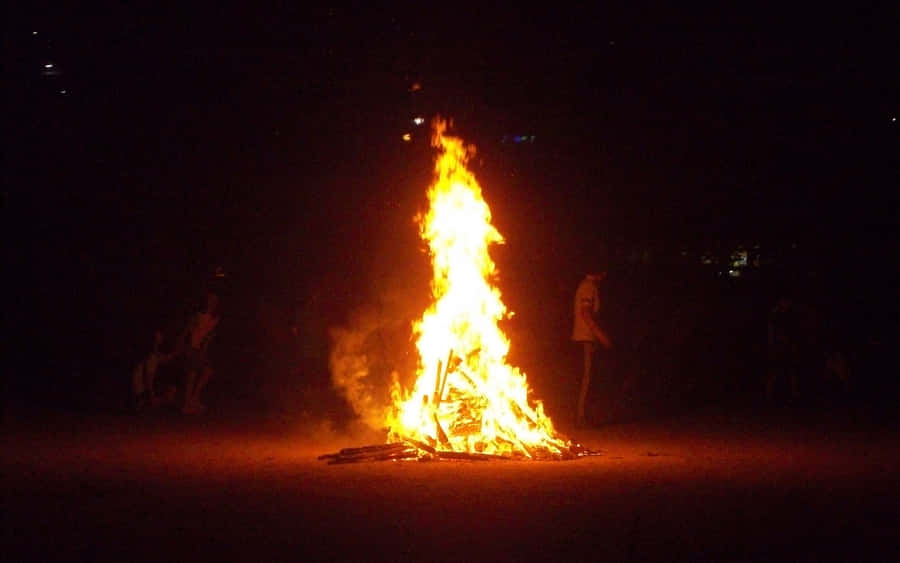 Cozy Fall Bonfire Under A Starlit Sky Wallpaper