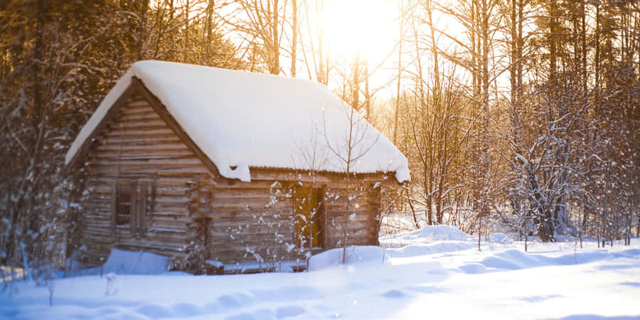 Cozy Winter Cabin In Snowy Forest Wallpaper