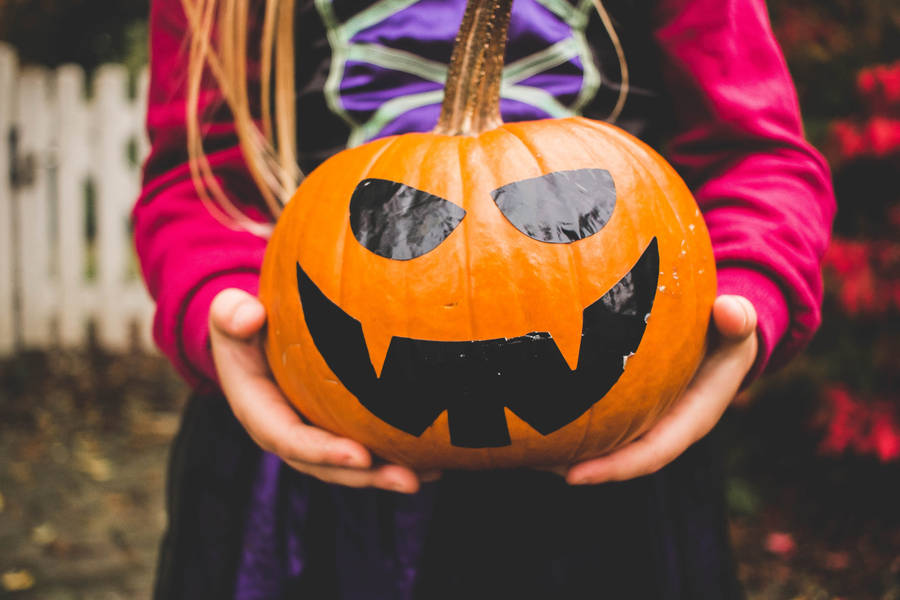 Cute Halloween Girl With Pumpkin Wallpaper
