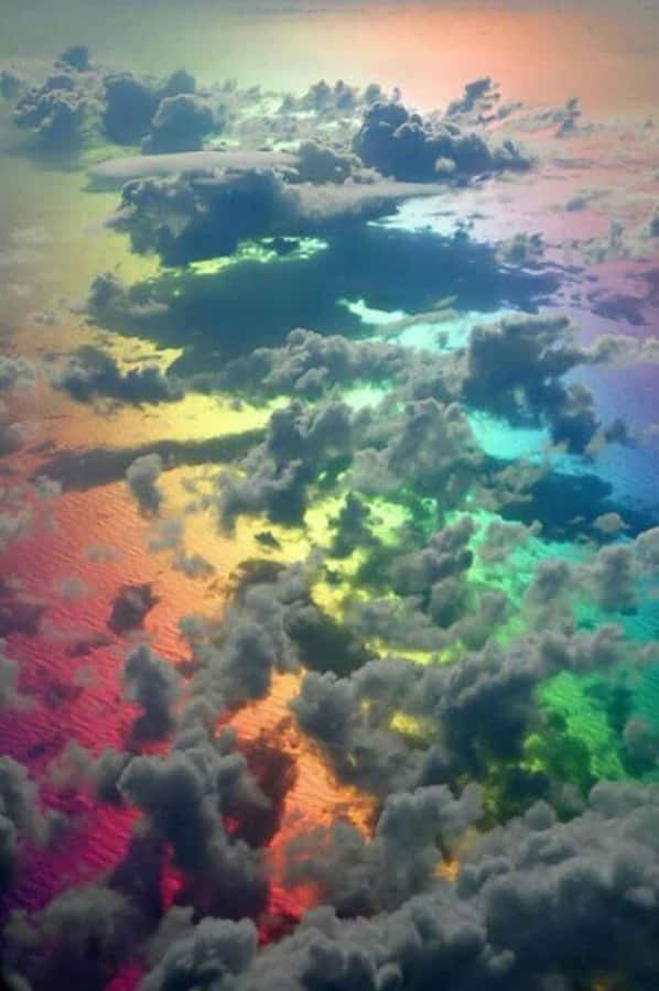 Cute Rainbow Behind Clouds Wallpaper