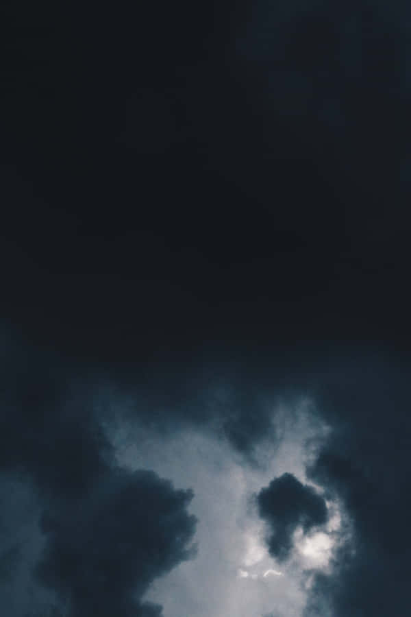 Dark Clouds Loom Over The Horizon Wallpaper