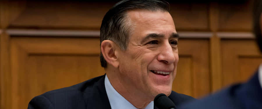 Darrell Issa Smiling Against Wooden Wall Wallpaper