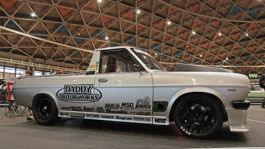 Datsun Classic Car: A Taste Of Vintage Excellence Wallpaper