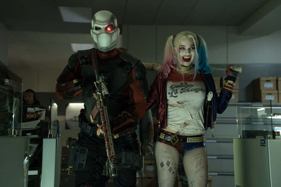 Deadshot And Harley Quinn In Epic Action Scene Wallpaper