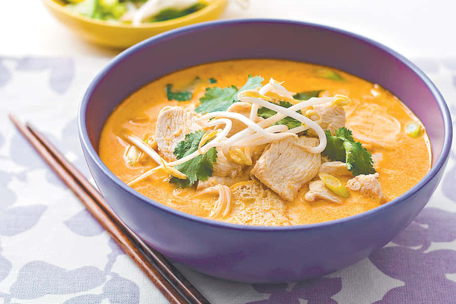 Decadent And Delicious Curry Laksa In A Blue Bowl Wallpaper