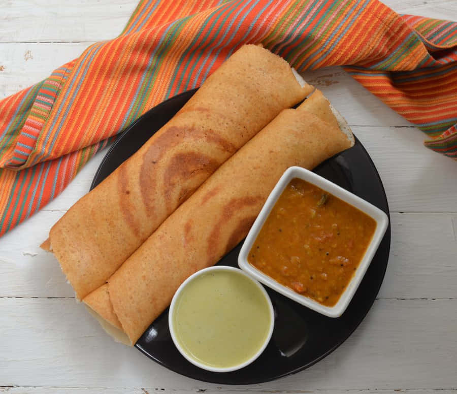 Delicious Crispy Golden Dosa Served Hot Wallpaper