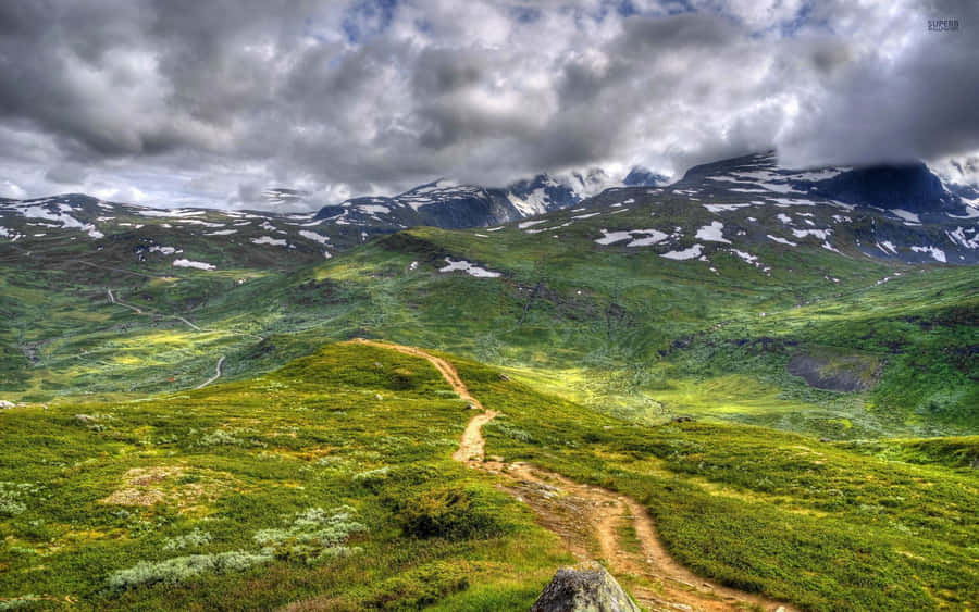 Dirt Road Passing Through The Mountain Wallpaper