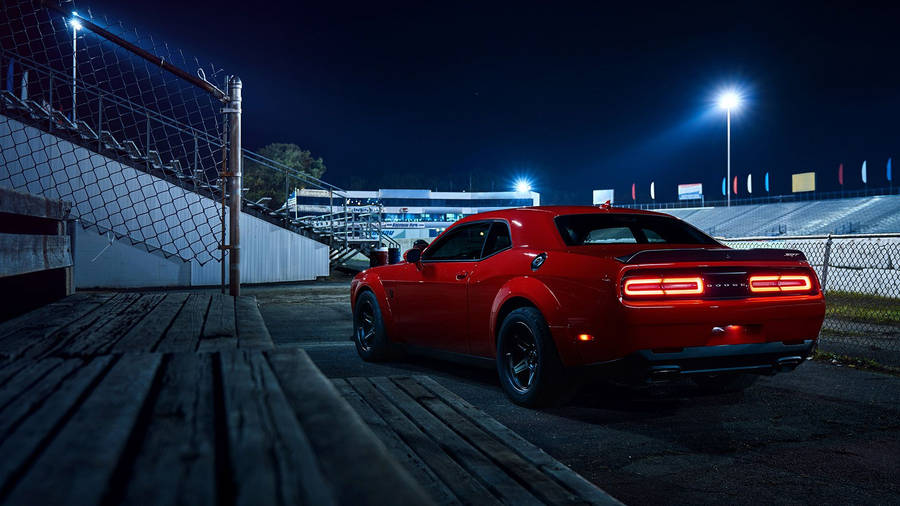 Dodge Challenger In Crimson Red - A Blend Of Power And Style Wallpaper