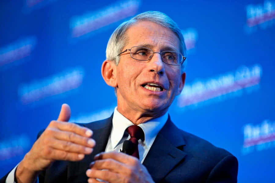 Dr. Anthony Fauci In A Press Conference Wallpaper