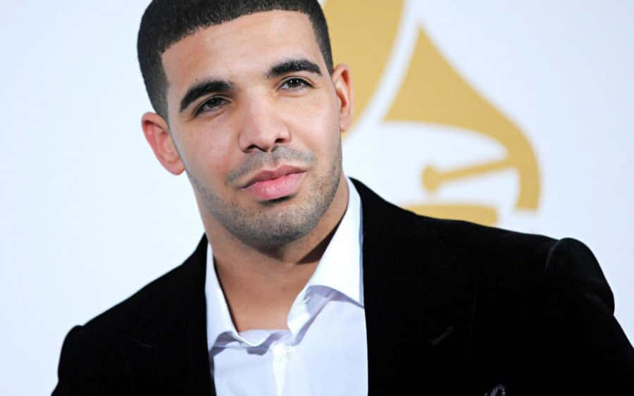 Drake Is Posing For A Photo At The Grammy Awards Wallpaper